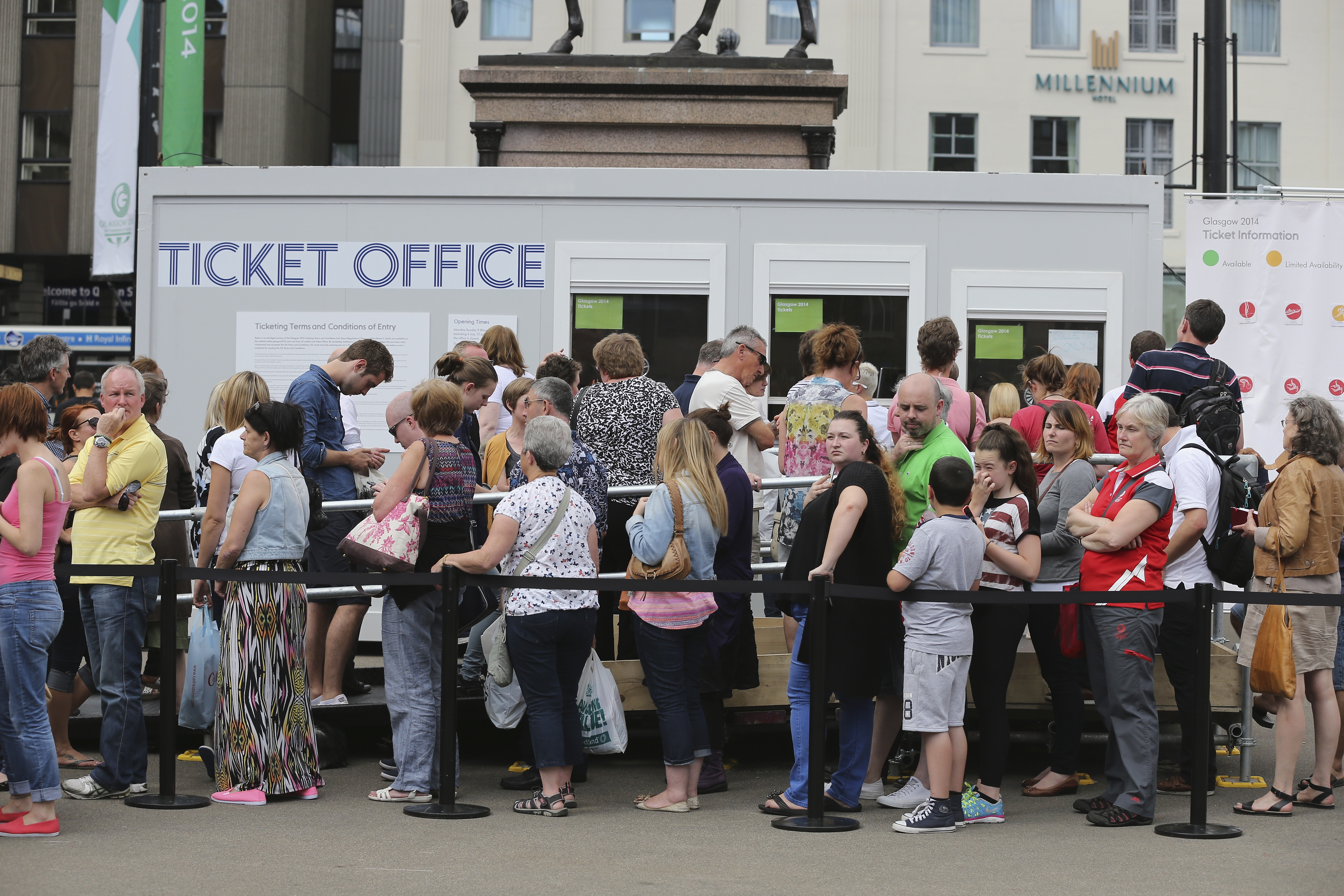 A queue of people outside a ticket office