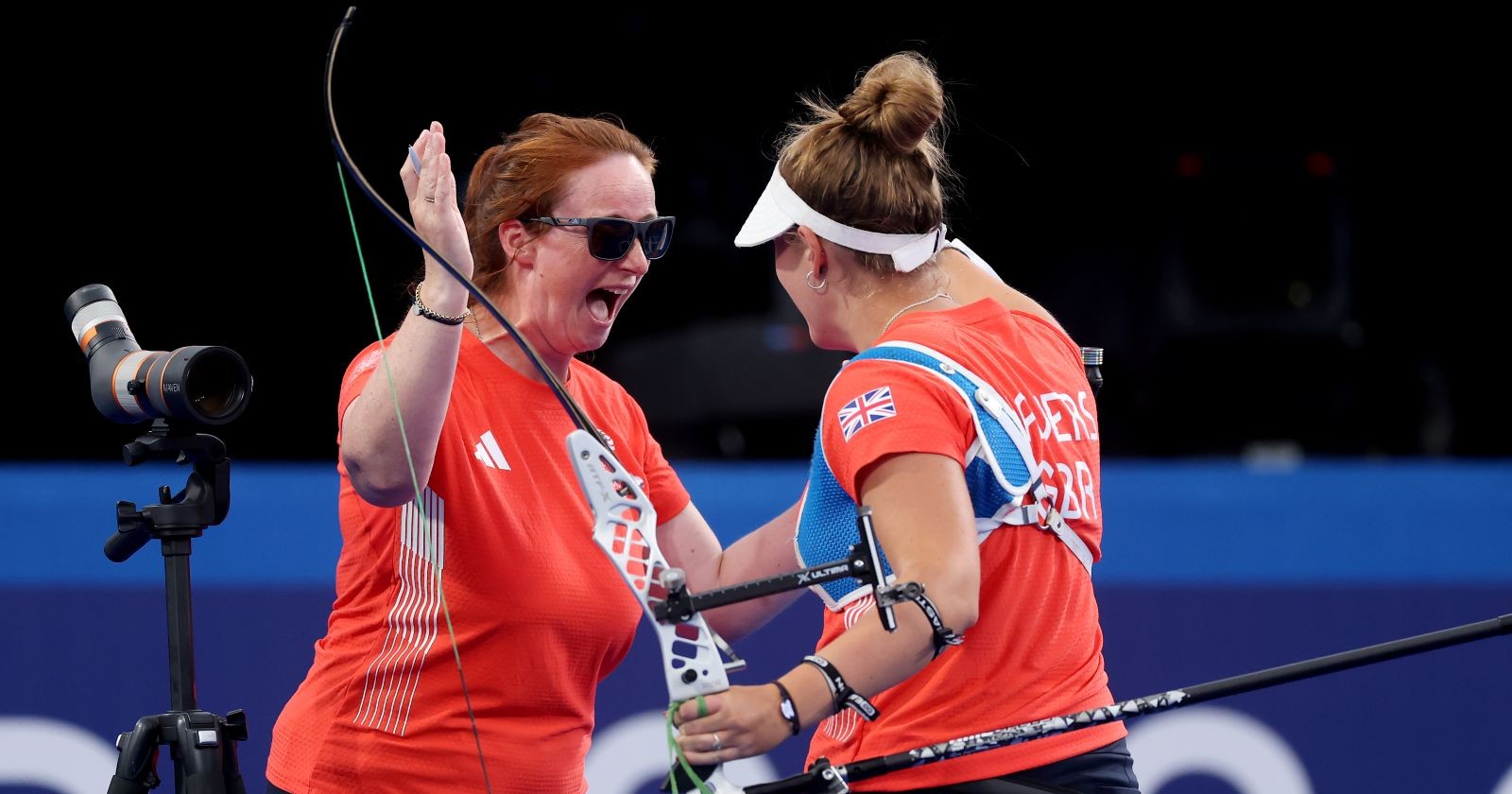 Archery athlete and their coach celebrating after a good shot