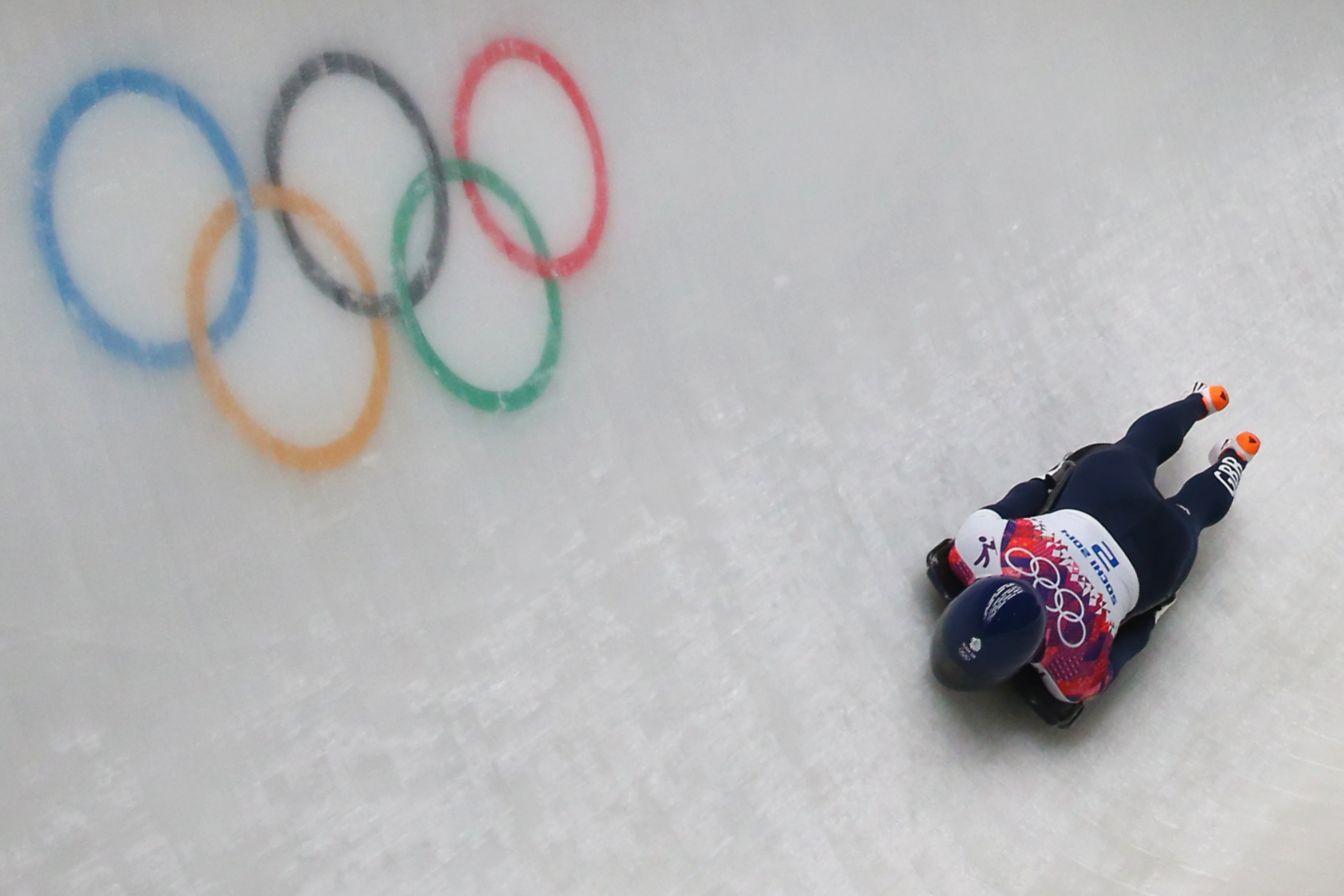skeleton athlete going head first down the ice slope at Sochi 2014 Olympic Games